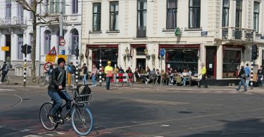 a person riding a bicycle on a street