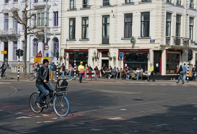 a person riding a bicycle on a street