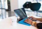 person using blue Microsoft Surface