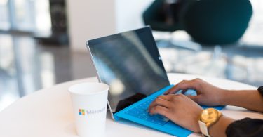 person using blue Microsoft Surface