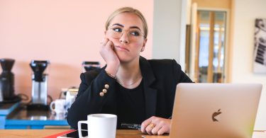woman in black long sleeve shirt using macbook
