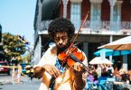 A man playing the violin or fiddle on the streets in New Orleans in the French Quarter