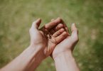 person's left hand over right hand