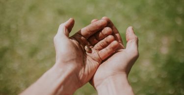 person's left hand over right hand