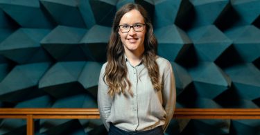 woman in white button up shirt and blue denim jeans wearing black framed eyeglasses
